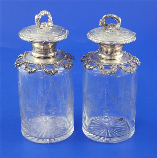 A pair of late 19th/early 20th century Portuguese silver mounted etched glass scent bottles,
